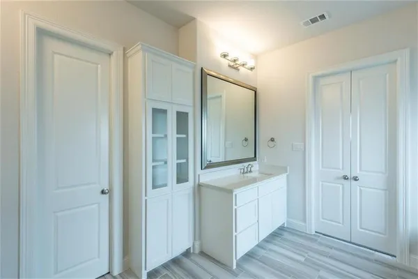 a bathroom with a double vanity sink and mirror