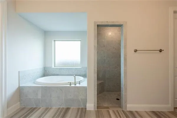 a bathroom with a tub and shower