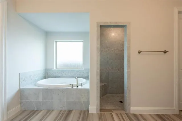 a bathroom with a tub and shower