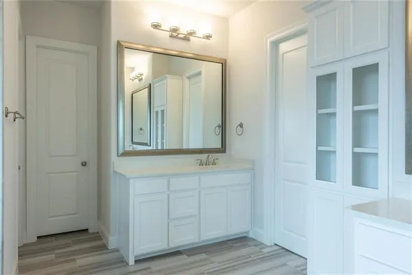 a bathroom with a double vanity sink and mirror