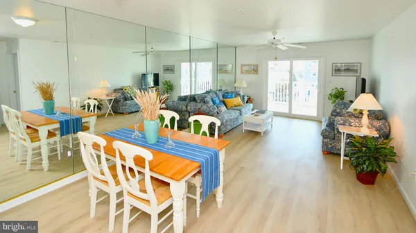 a living room with furniture a chandelier and a wooden floor