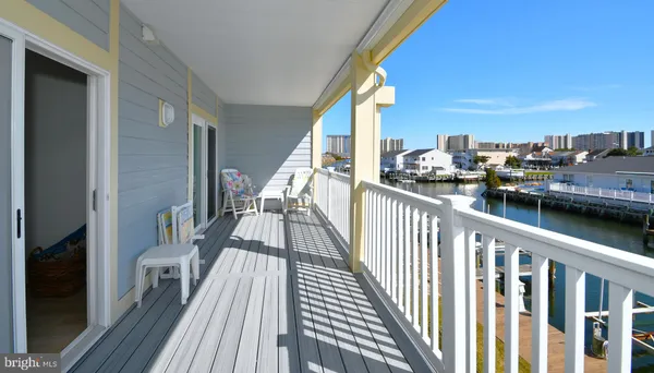 a view of a balcony with wooden floor and fence