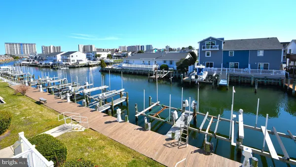 a view of a lake with a chairs and table on the terrace