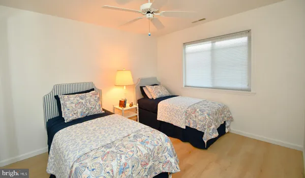 a bedroom with two beds and a chandelier