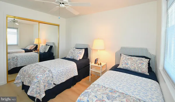 a bedroom with two beds and a chandelier