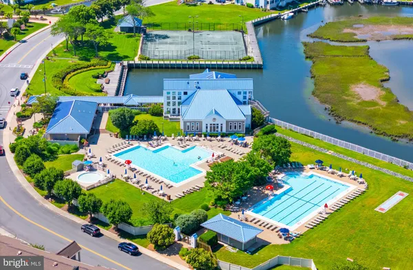 a view of a house with swimming pool and sitting area
