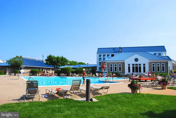 a view of a swimming pool and lounge chairs