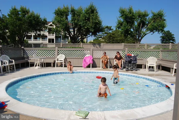 a swimming pool with outdoor seating and yard