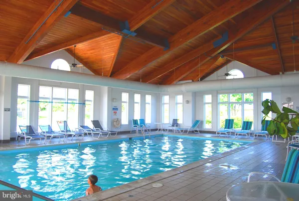 a living room with furniture a rug and a large window