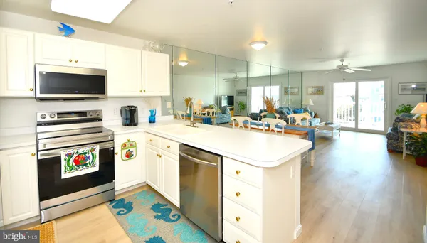 a kitchen with a sink stove and microwave