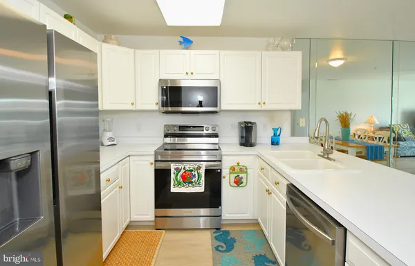 a kitchen with a sink a stove and refrigerator