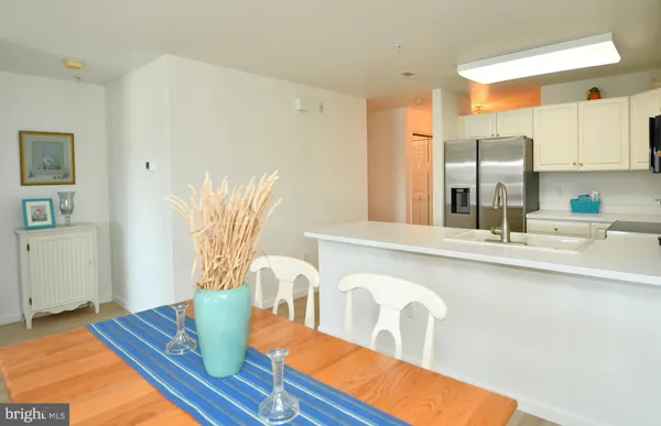 a kitchen with stainless steel appliances granite countertop a sink and a refrigerator