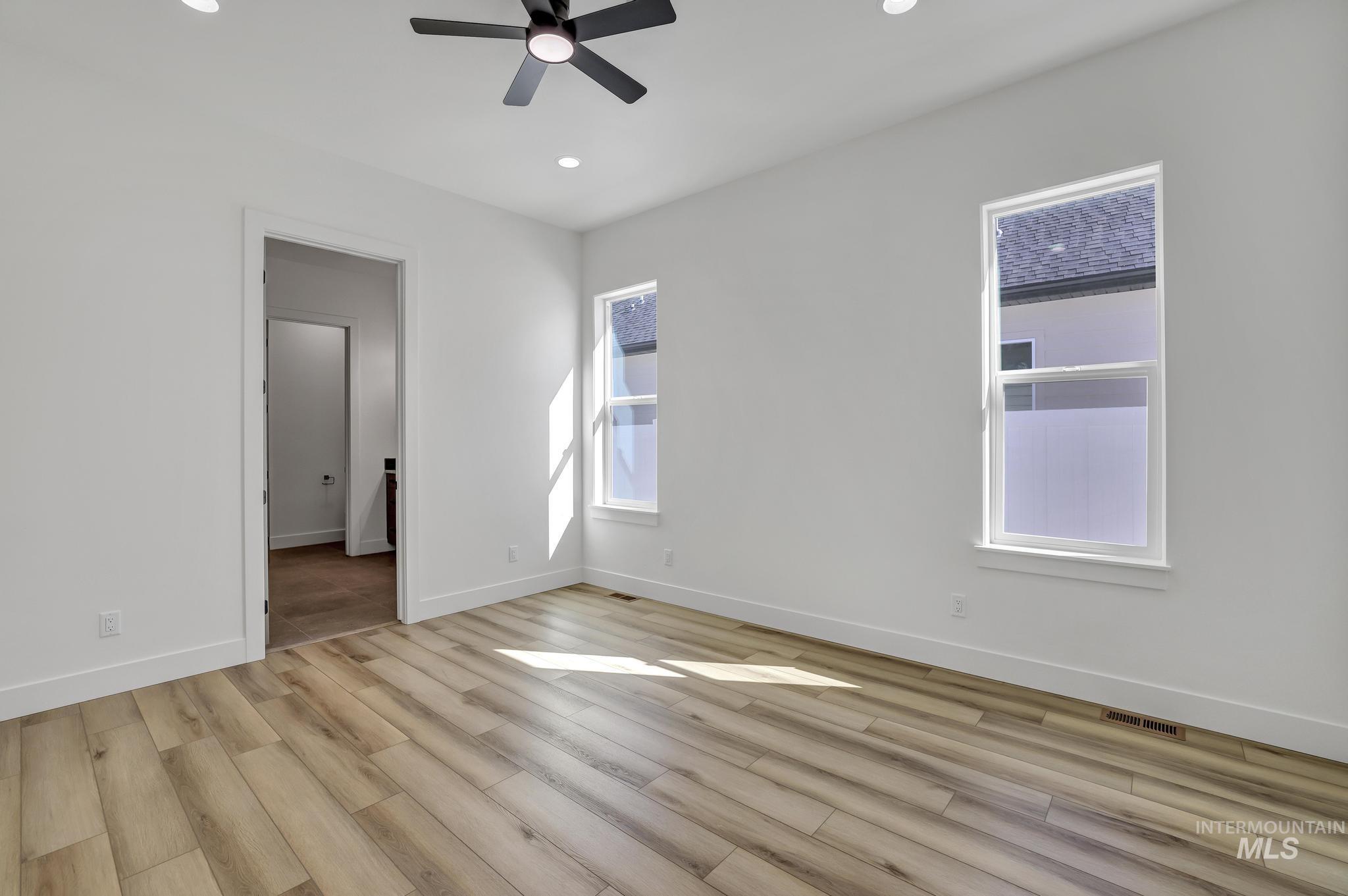 521 Falling Leaf Lane Twin Falls, ID 83301 - Photo 28 of 42 Unfurnished bedroom with light wood-style floors, recessed lighting, and ceiling fan
