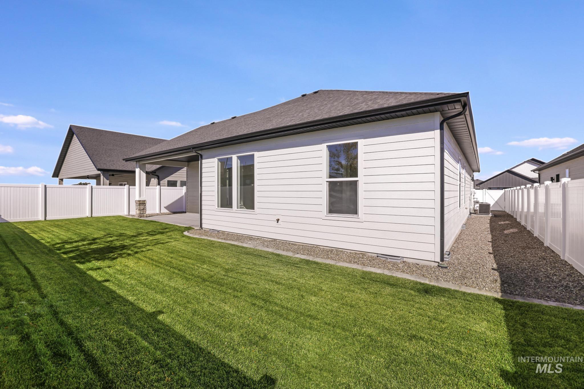 521 Falling Leaf Lane Twin Falls, ID 83301 - Photo 34 of 42 Back of property with a patio area, a fenced backyard, and a shingled roof