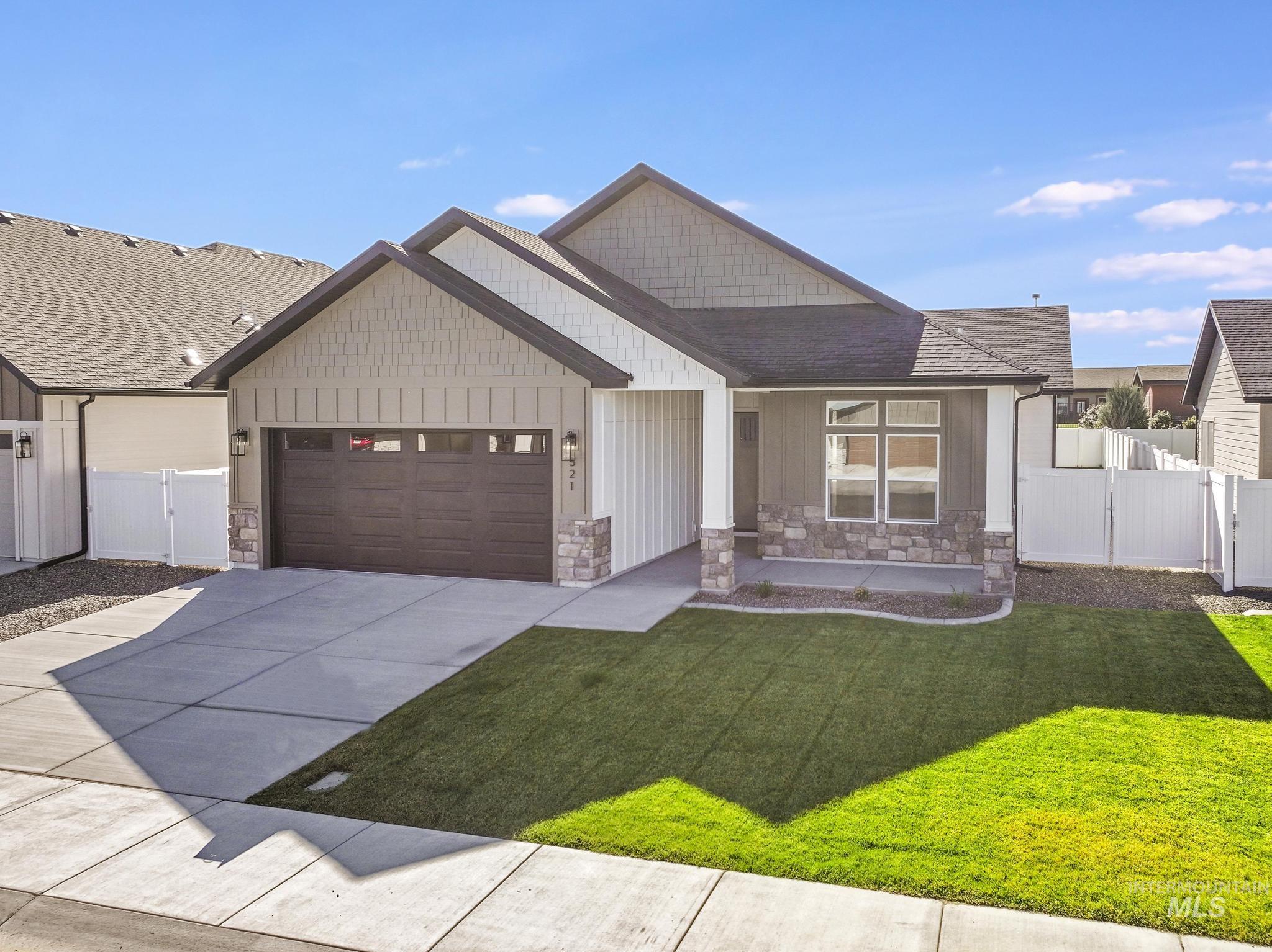 521 Falling Leaf Lane Twin Falls, ID 83301 - Photo 4 of 42 Modern farmhouse style home with stone siding, an attached garage, driveway, and covered porch