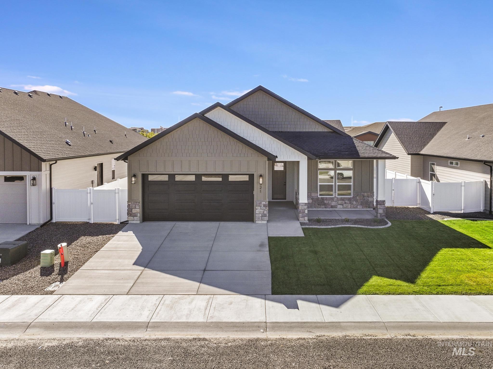 521 Falling Leaf Lane Twin Falls, ID 83301 - Photo 6 of 42 Modern inspired farmhouse with stone siding, a gate, board and batten siding, and a garage