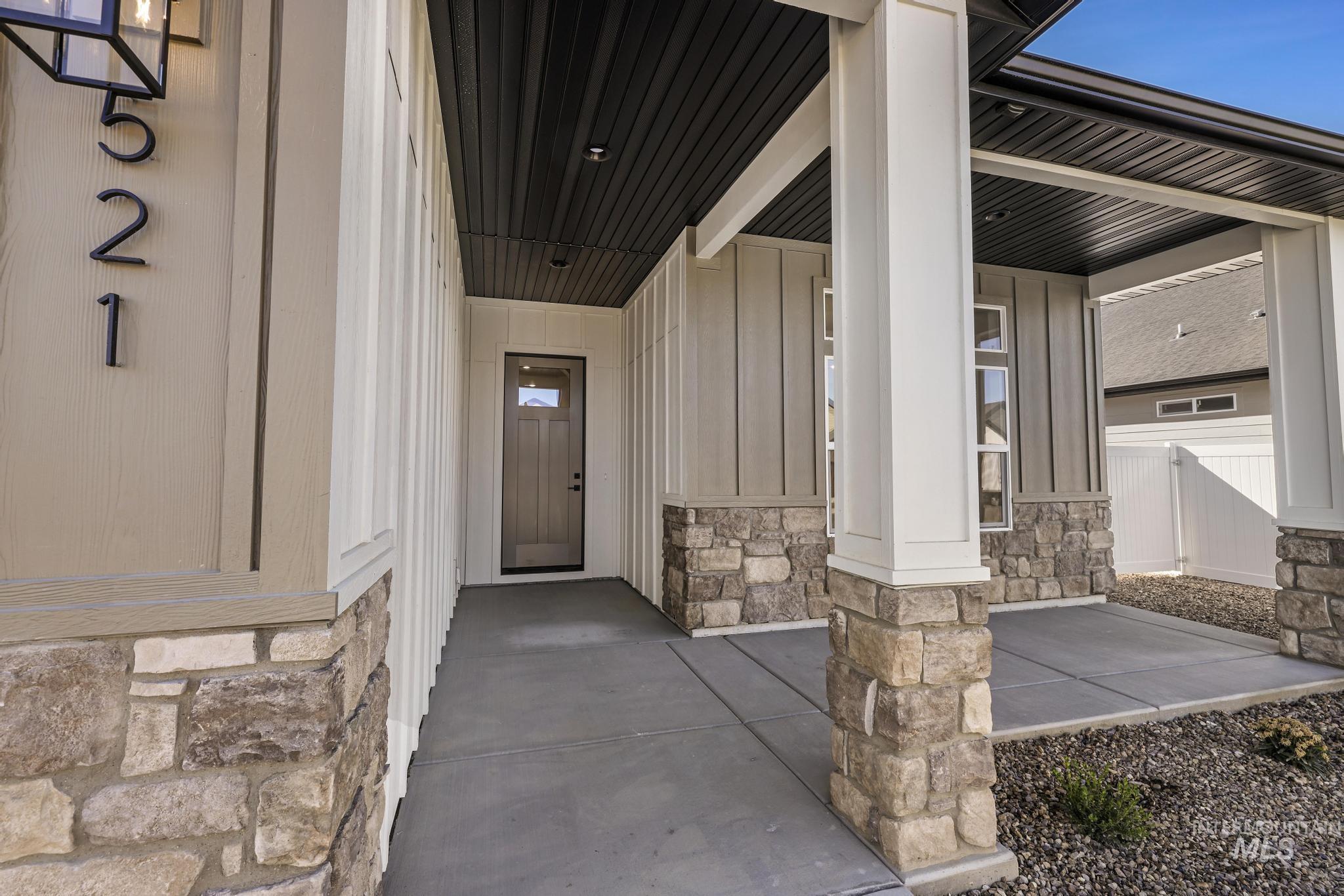521 Falling Leaf Lane Twin Falls, ID 83301 - Photo 8 of 42 Entrance to property featuring stone siding, a porch, and board and batten siding