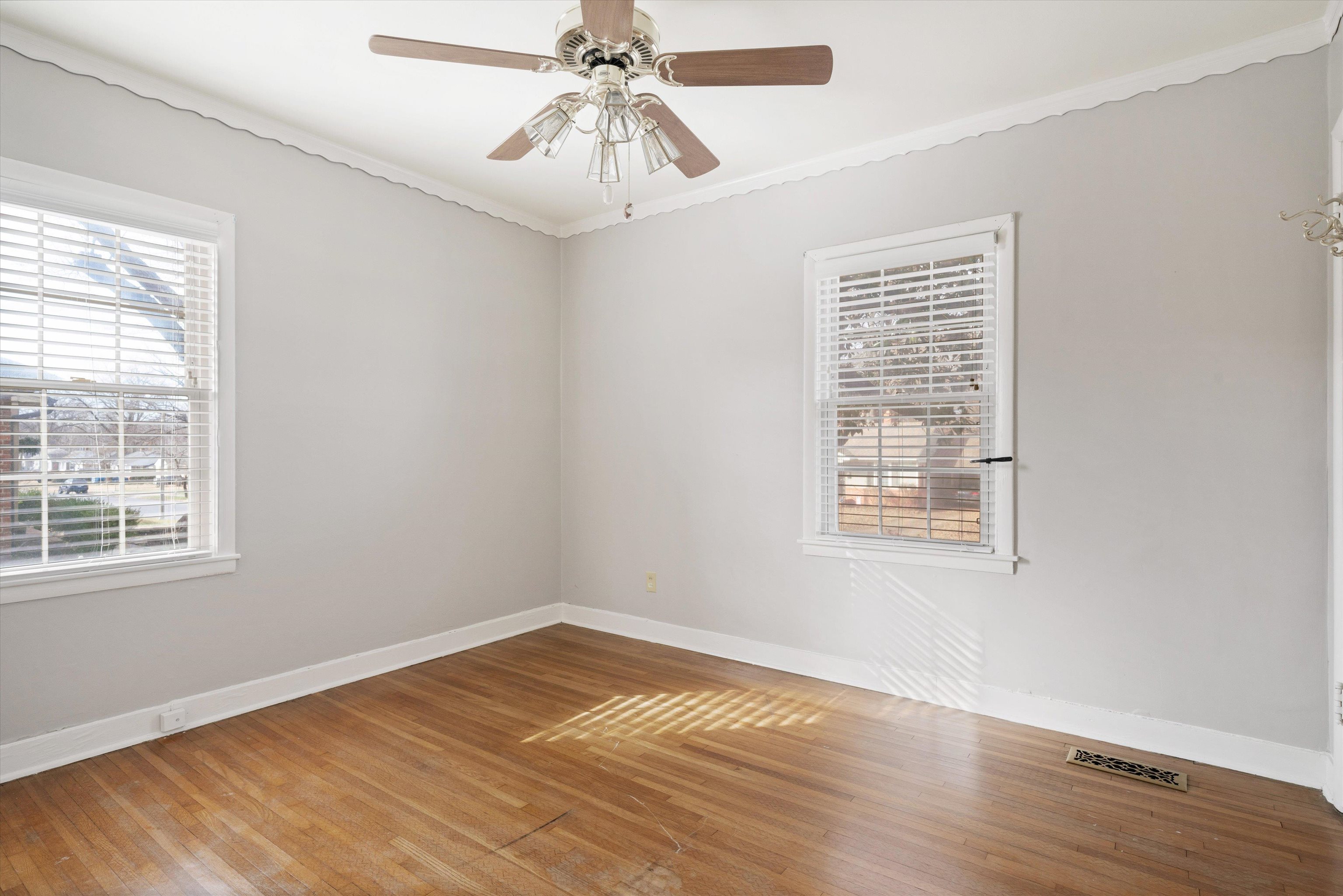 4863 Amboy Road Memphis, TN 38117 - Photo 15 of 26 a view of an empty room with wooden floor and a window