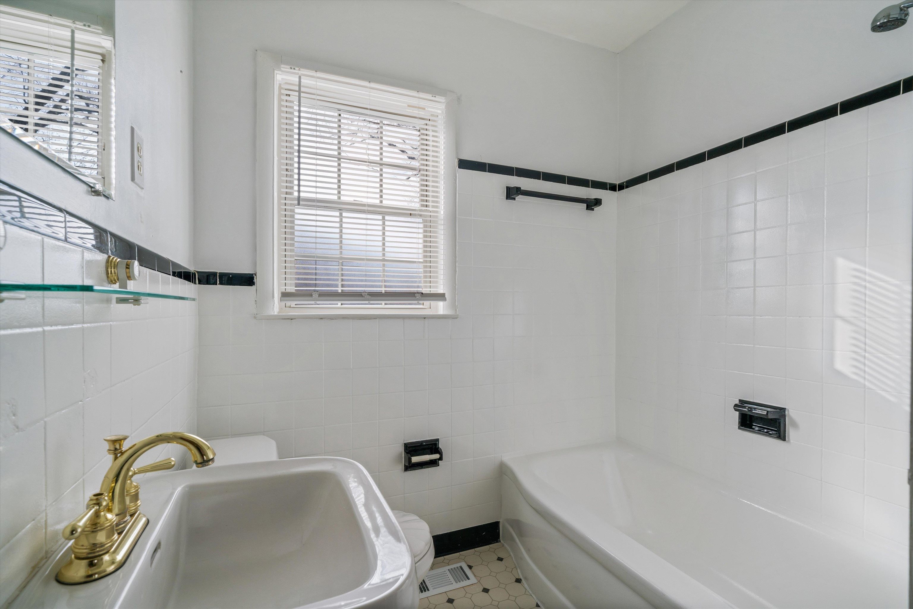 4863 Amboy Road Memphis, TN 38117 - Photo 17 of 26 a bathroom with a sink and bathtub with toilet