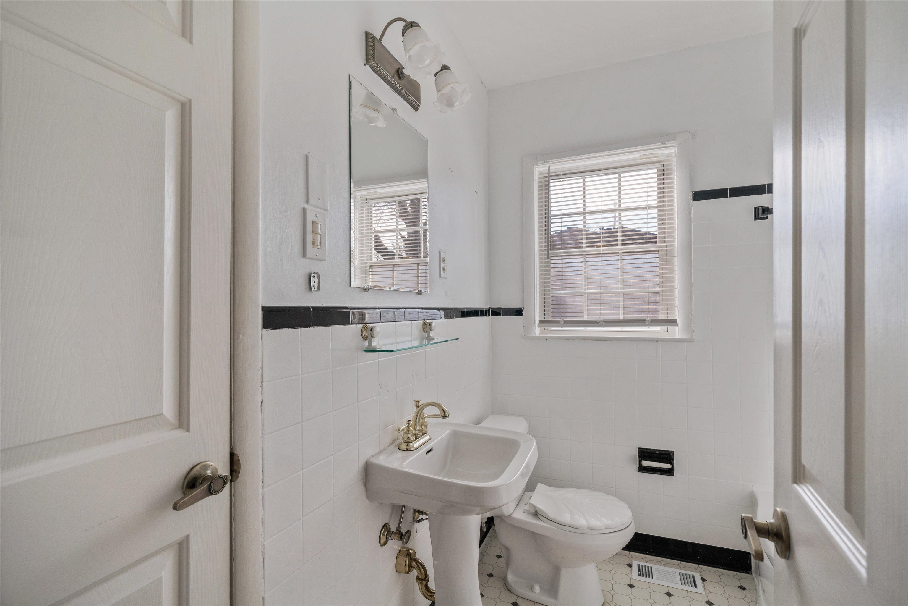 4863 Amboy Road Memphis, TN 38117 - Photo 18 of 26 a bathroom with a sink toilet and a mirror