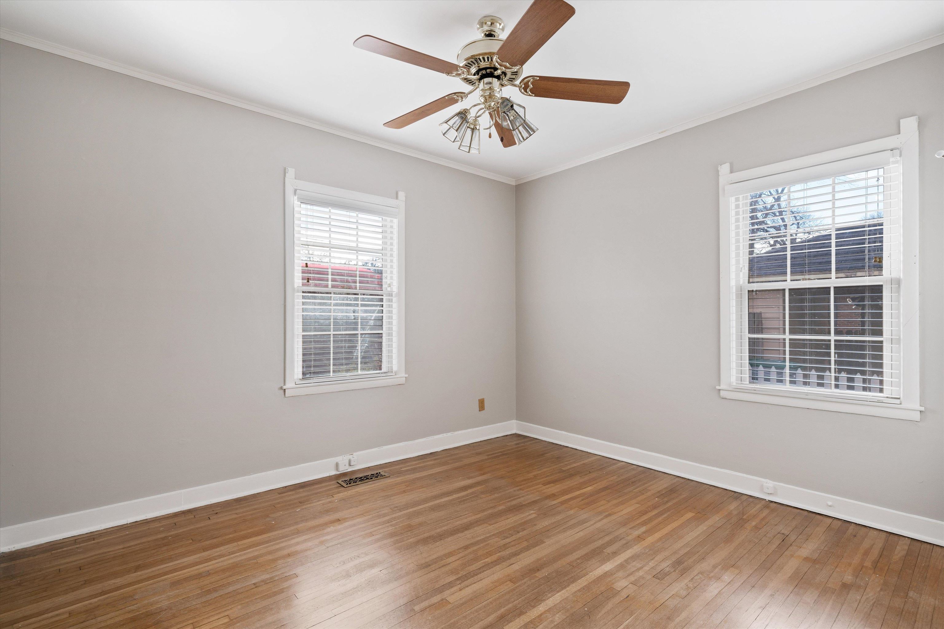 4863 Amboy Road Memphis, TN 38117 - Photo 20 of 26 a view of an empty room with wooden floor and a window