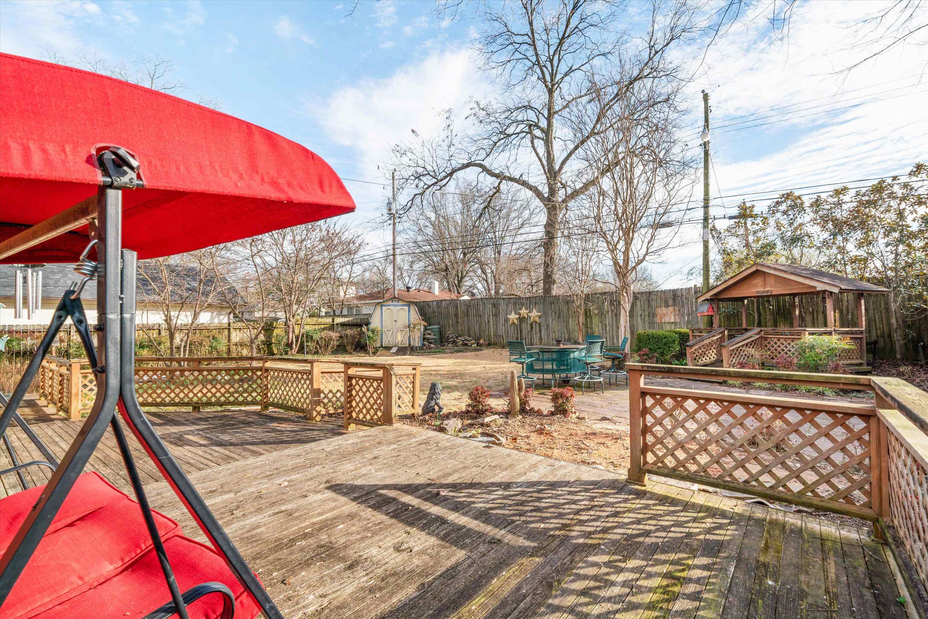 4863 Amboy Road Memphis, TN 38117 - Photo 25 of 26 a view of a roof deck with table and chairs under an umbrella
