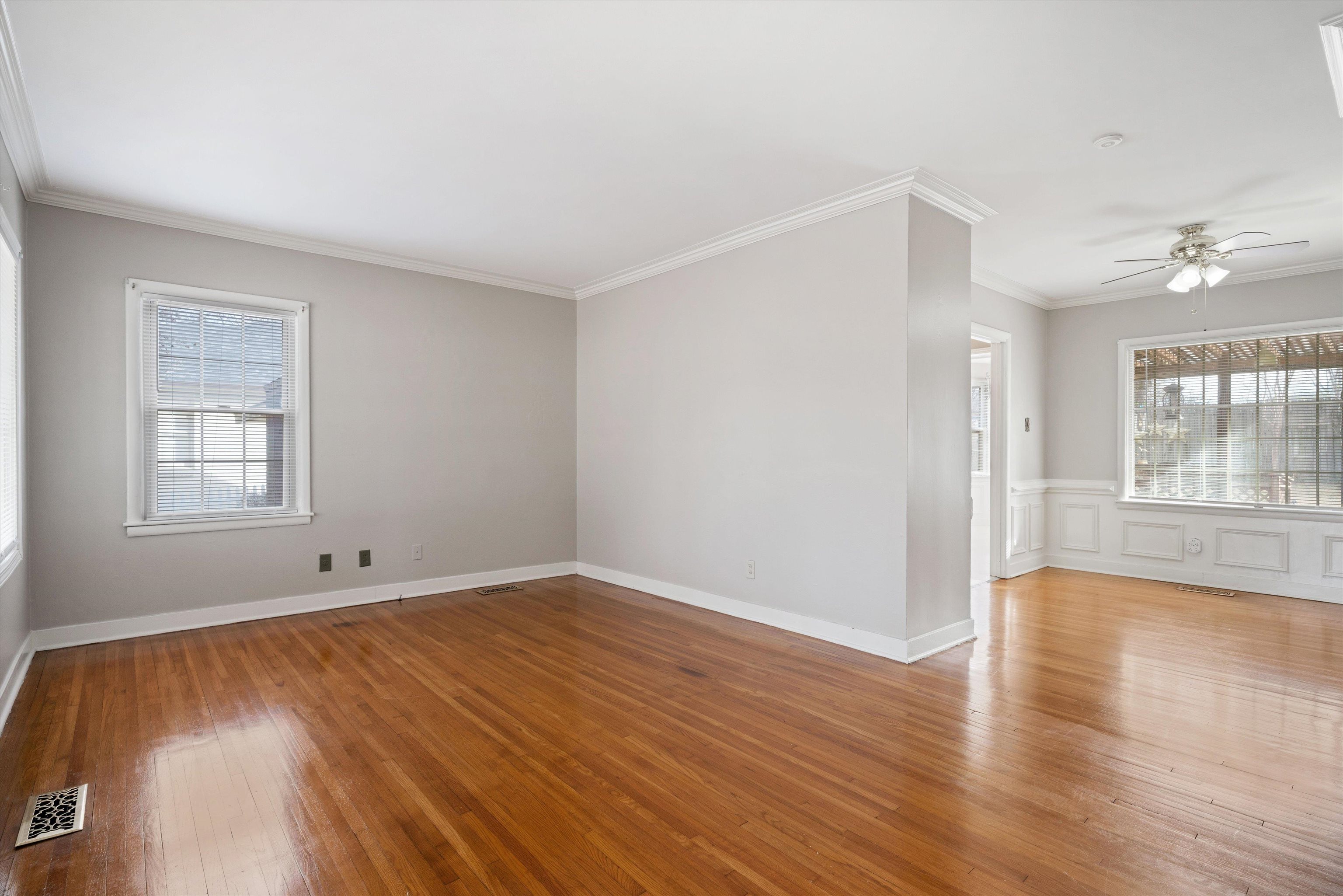4863 Amboy Road Memphis, TN 38117 - Photo 4 of 26 an empty room with wooden floor and windows