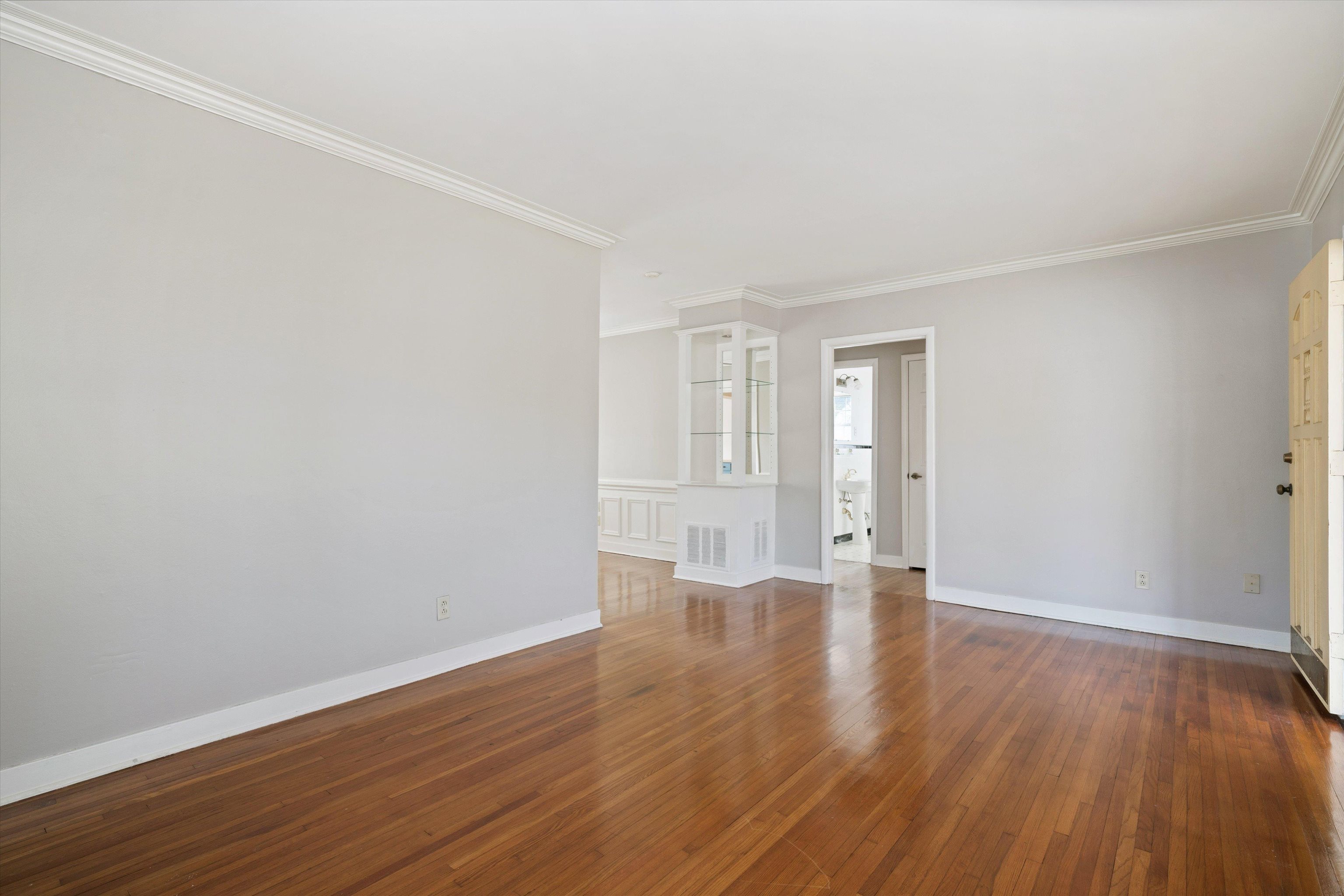 4863 Amboy Road Memphis, TN 38117 - Photo 5 of 26 a view of an empty room with wooden floor and window