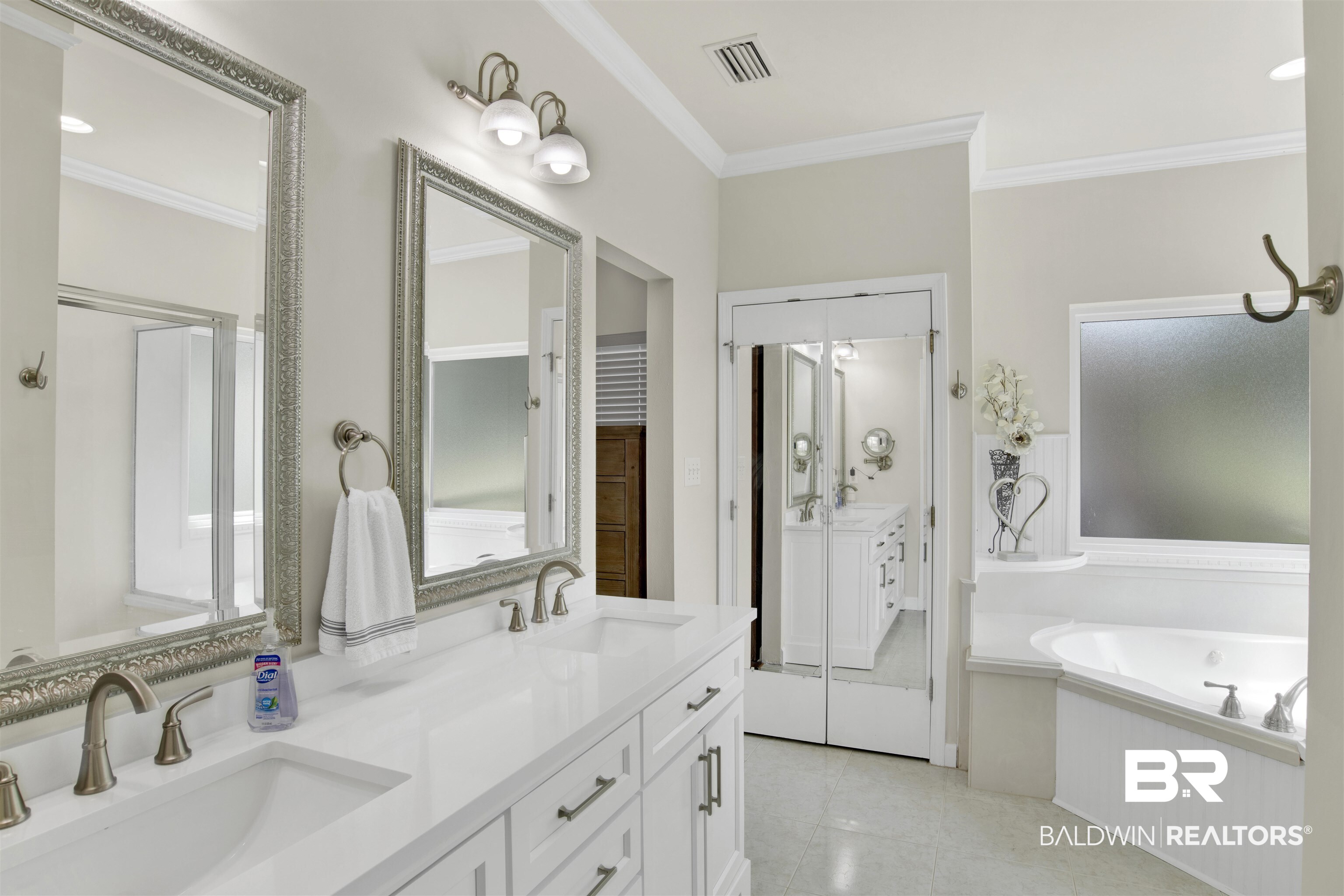 638 Southern Way Daphne, AL 36527 - Photo 16 of 26 Bathroom featuring tile patterned floors, ornamental molding, a bath, and double sink vanity