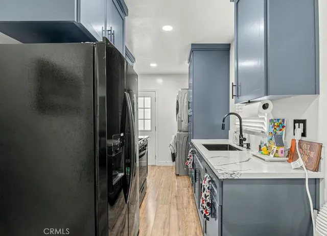 a kitchen with granite countertop a sink appliances and cabinets