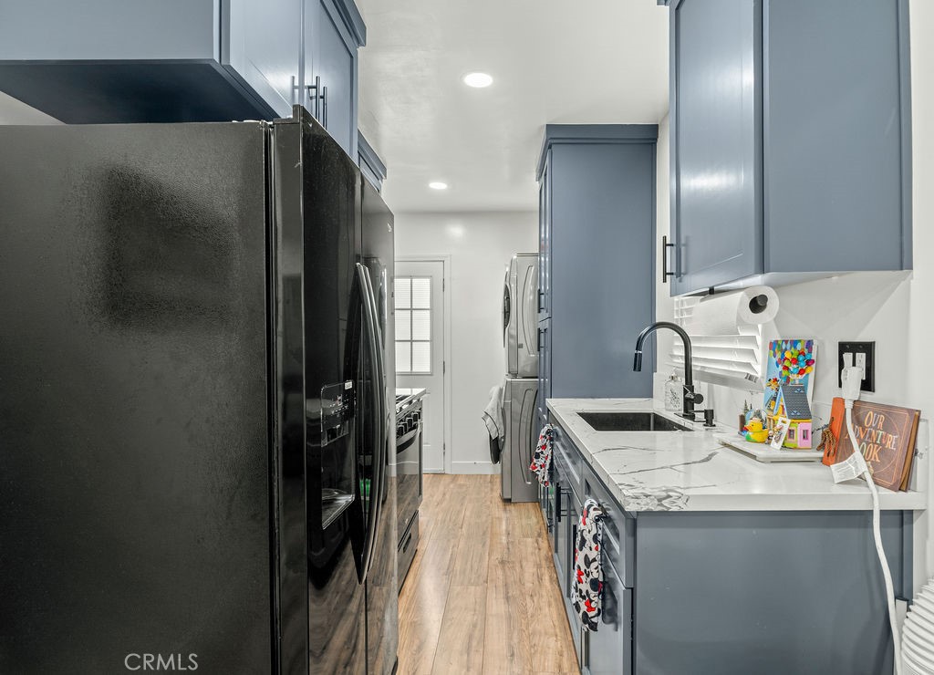2015 Wayside Street Compton, CA 90222 - Photo 11 of 27 a kitchen with granite countertop a sink appliances and cabinets