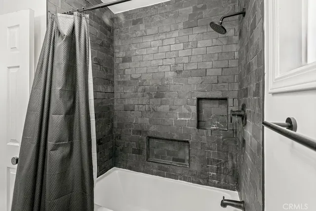 a bathroom with a shower and a sink