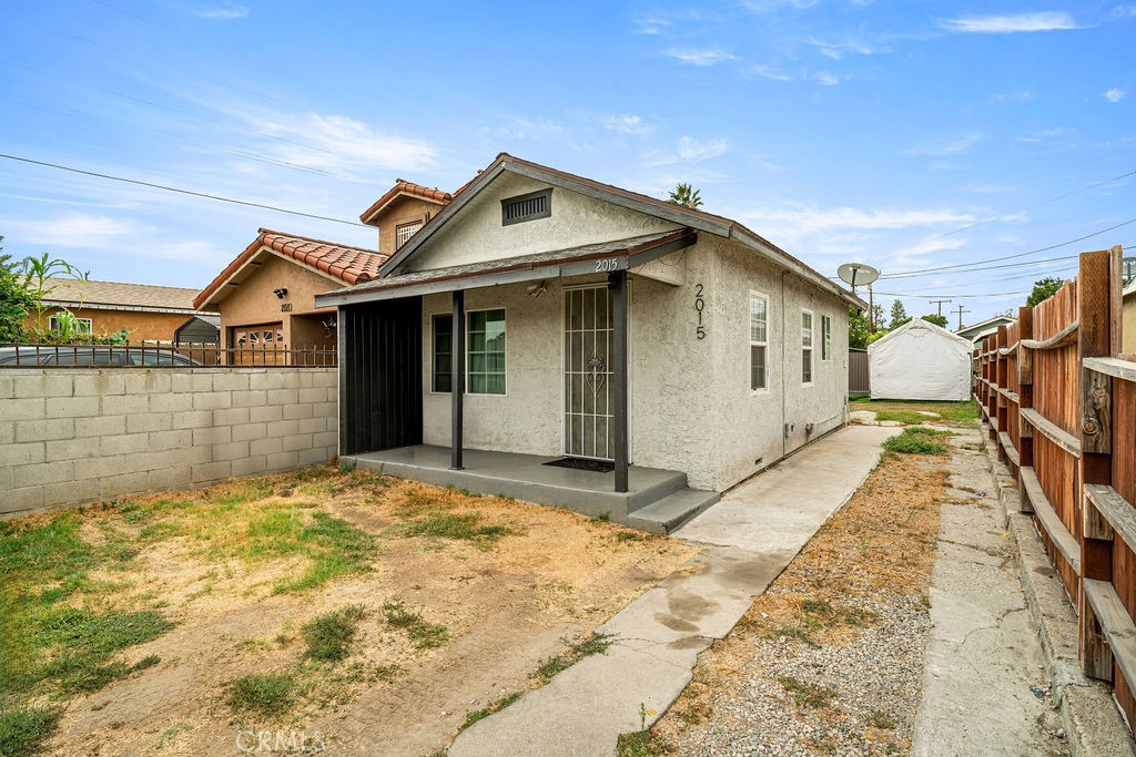 2015 Wayside Street Compton, CA 90222 - Photo 3 of 27 a view of a white house with a large space in front of it