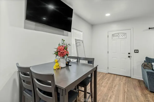 a view of a dining room with furniture and wooden floor