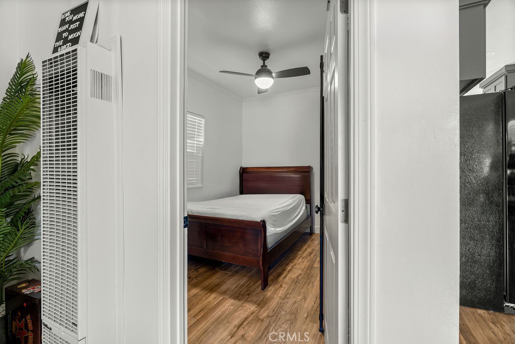 2015 Wayside Street Compton, CA 90222 - Photo 8 of 27 a bedroom with wooden floor and ceiling fan
