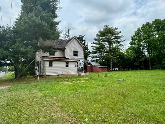 a view of a house with a yard porch and sitting area