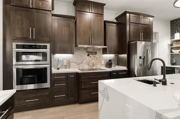 a kitchen with stainless steel appliances a refrigerator and a stove