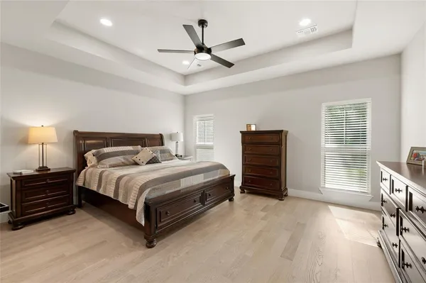 a bedroom with a bed and a ceiling fan