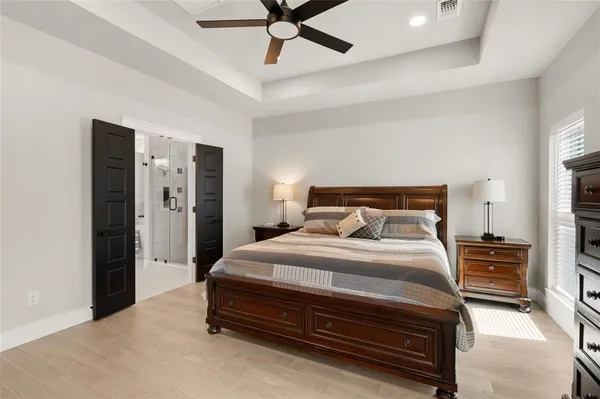 a bedroom with bed and a chandelier