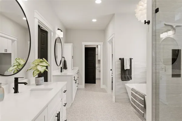 a bathroom with double vanity sink a mirror and a shower