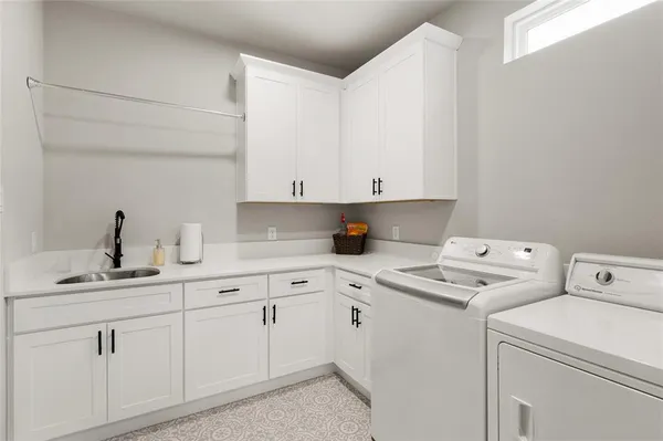 a view of cabinets with washer and dryer
