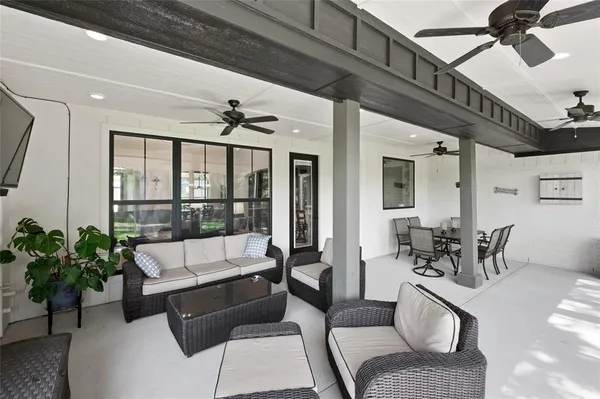 a living room with furniture a chandelier and a rug