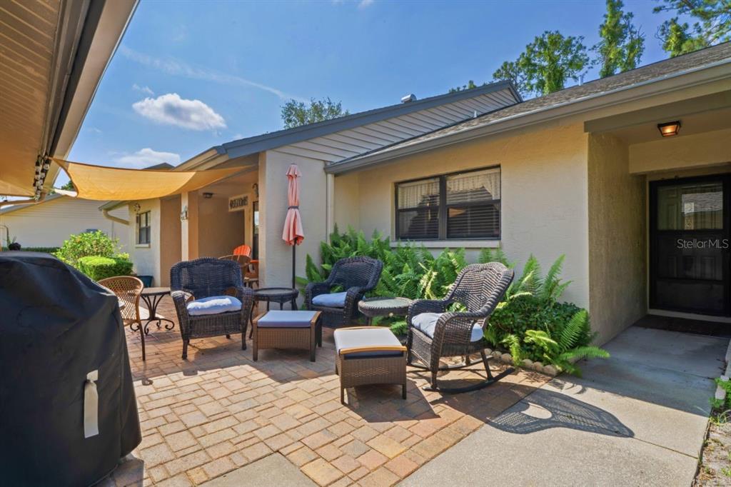 a building outdoor space with patio furniture and potted plants