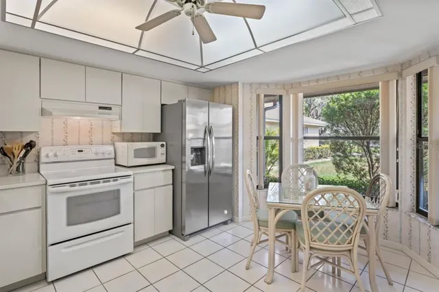 a kitchen with white cabinets and white stainless steel appliances