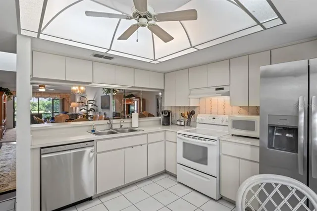 a kitchen with a sink and white cabinets