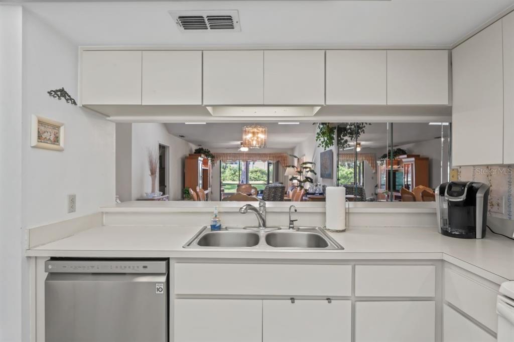 3274 Lori Lane, Unit 2 New Port Richey, FL 34655 - Photo 17 of 56 a kitchen with a sink and white cabinets