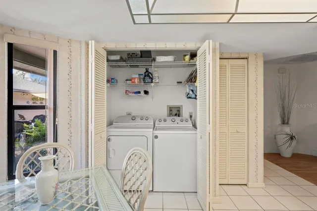 a bedroom with a bed a window and a chandelier