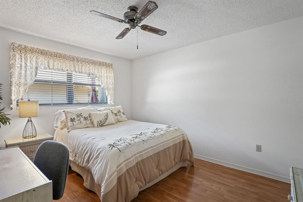 3274 Lori Lane, Unit 2 New Port Richey, FL 34655 - Photo 21 of 56 a bedroom with a bed a window and a chandelier