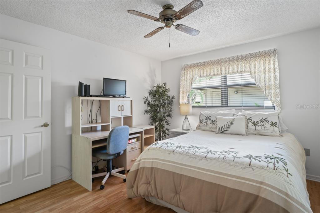 3274 Lori Lane, Unit 2 New Port Richey, FL 34655 - Photo 23 of 56 a bedroom with a bed and a chandelier