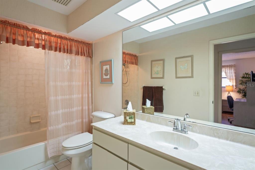3274 Lori Lane, Unit 2 New Port Richey, FL 34655 - Photo 25 of 56 a bathroom with a sink toilet and shower